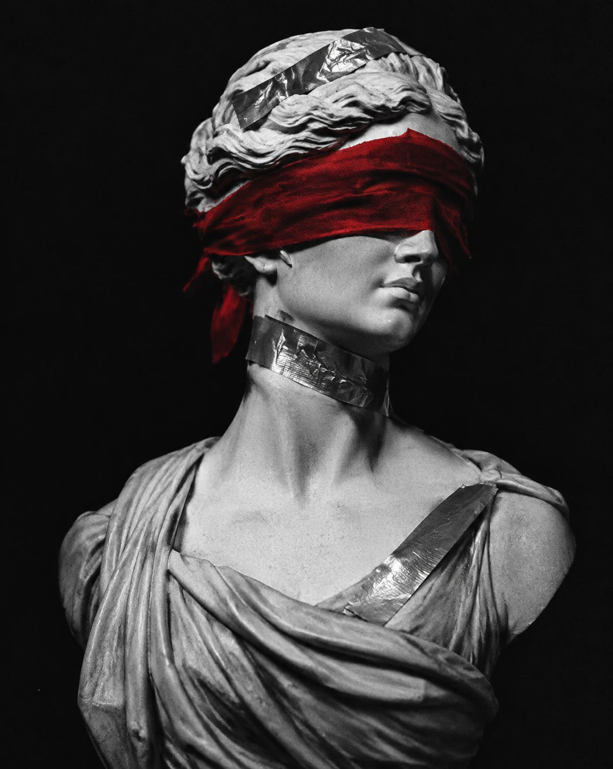 Marble bust with crimson blindfold and silver tape